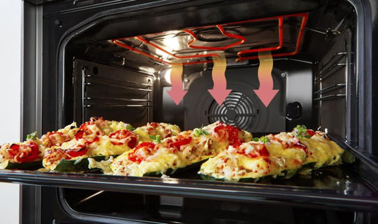 Open electric oven with stuffed vegetables baking on a tray inside showing heating elements and convection fan airflow