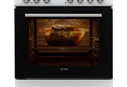 VOX electric oven with glass door roasting chicken inside, black and white stove design, control knobs on top